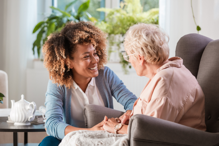 Hospice volunteer listening to elderly woman