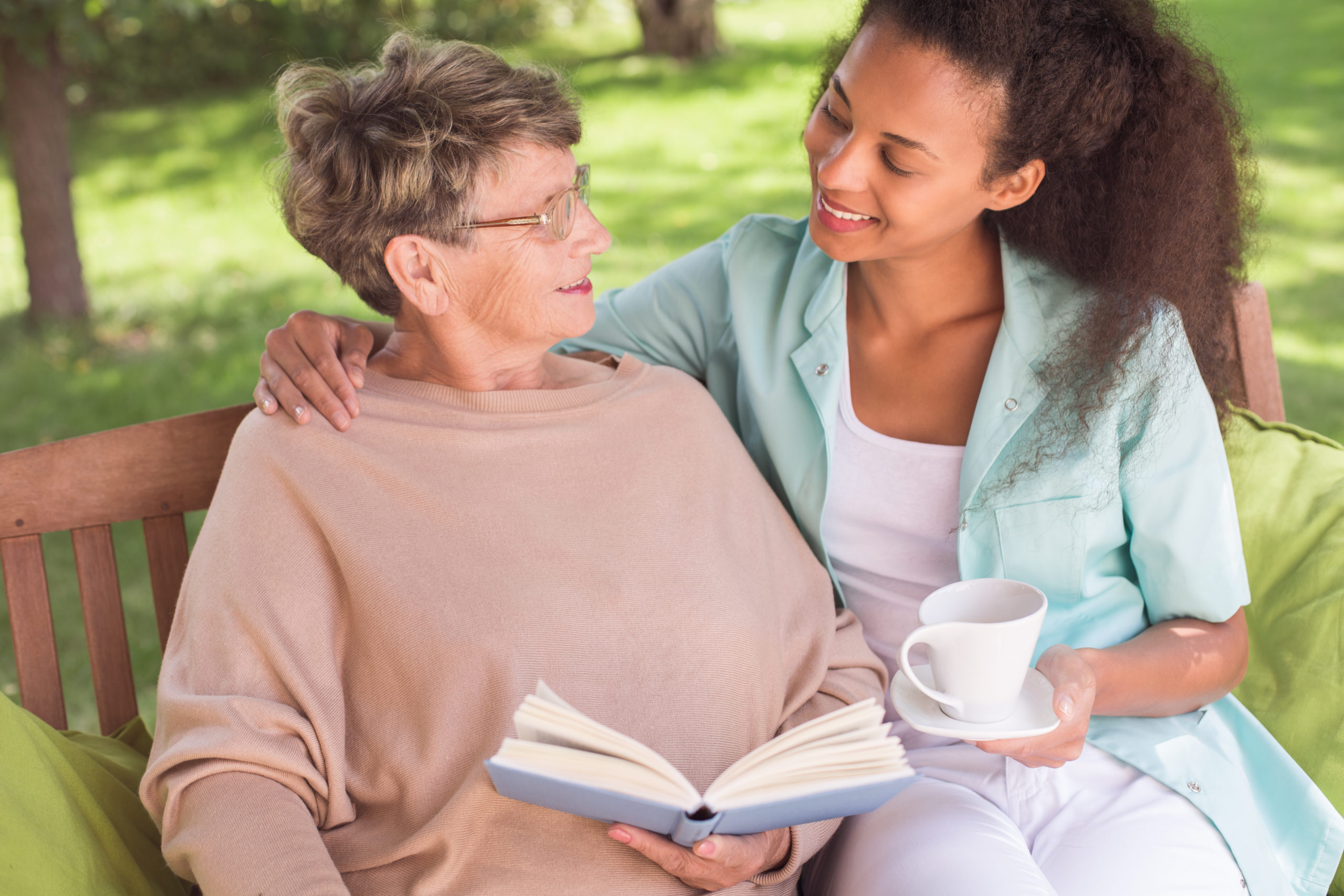 volunteer and elder reading scaled